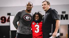 Boy who lost family in Athens house fire bonds with UGA football players