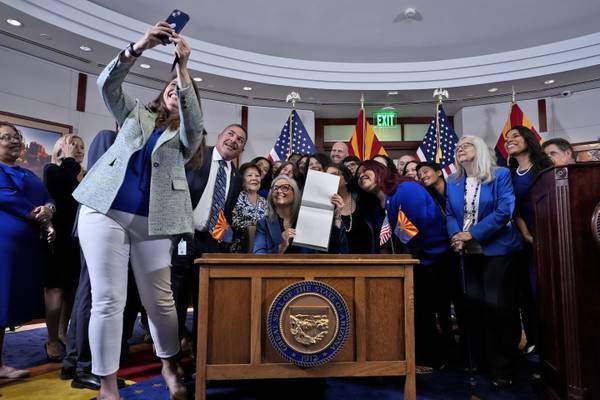 Arizona governor's signing of abortion law repeal follows political fight by women lawmakers