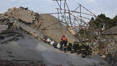 Rescuers contact some workers alive in the rubble of a deadly building collapse in South Africa